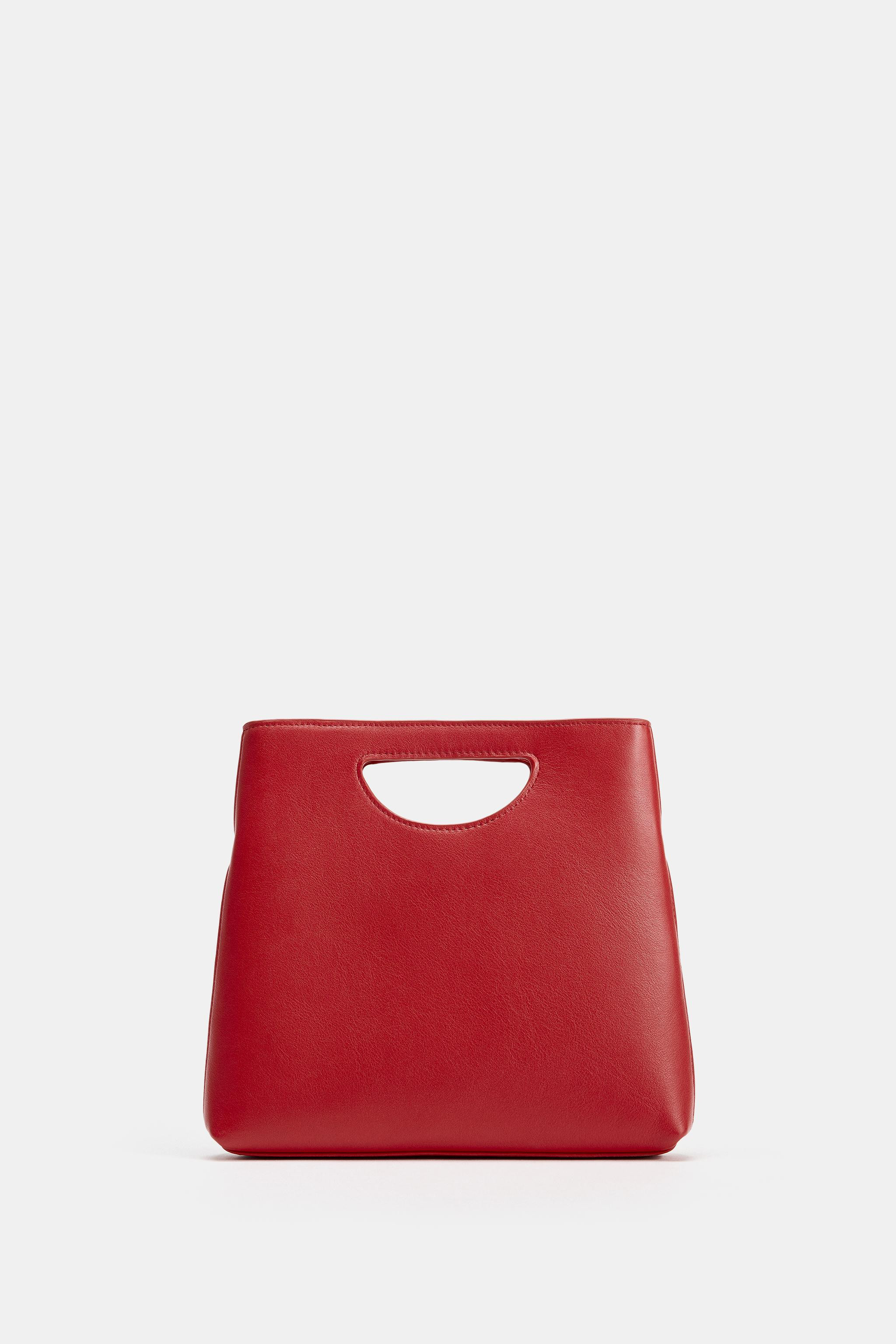 Leather handbag. Asymmetrical silhouette. Handle with integrated side cutouts and removable cross... | Zara US