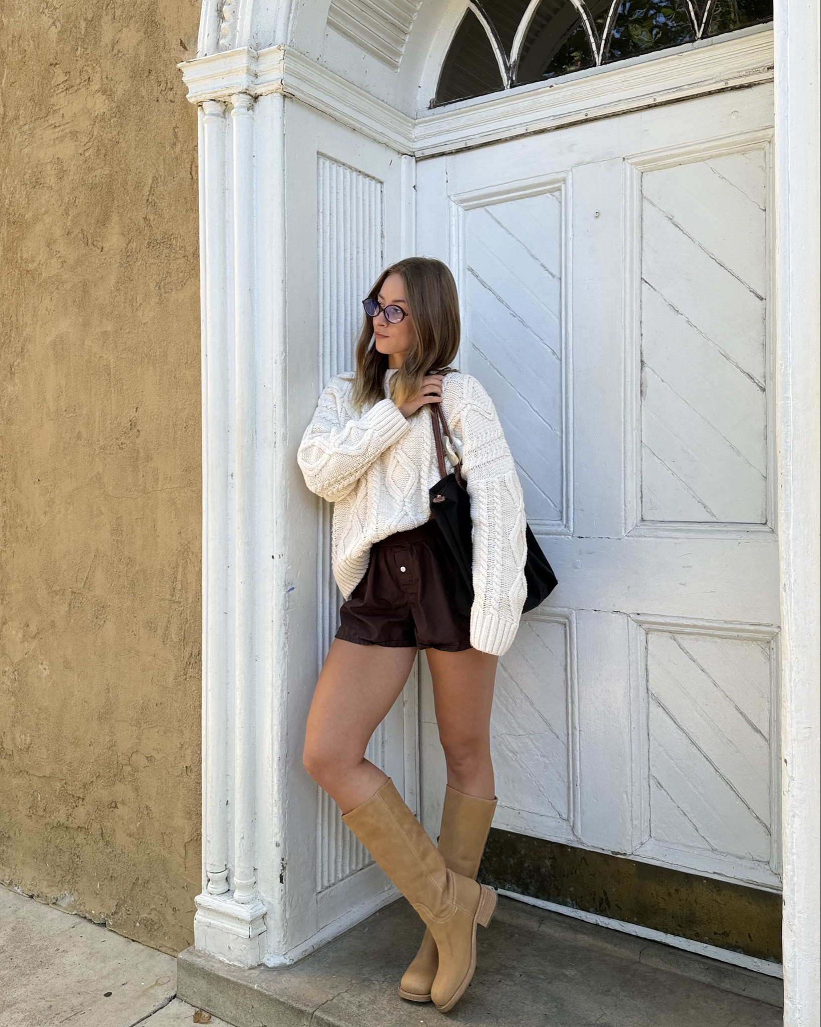 8/26/25 The perfect summer → fall outfit for a 70° day 🍂🤍 Wearing my oversized cable knit sweater from Princess Polly with my Aritzia brown boxer shorts + my Frye-inspired boots from Steve Madden. Cozy on top, easy + breezy on the bottom — my go-to transitional uniform.

#LTKShoeCrush #LTKStyleTip