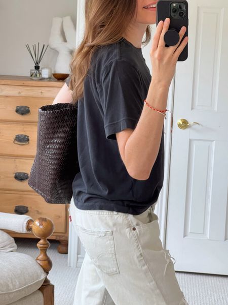 Styling a black tee and baggy white jeans today. Throwing some dark brown in the mix too. Love this woven leather tote from Madewell. Overall vibe is minimalist cool.

#LTKstyletip #LTKitbag