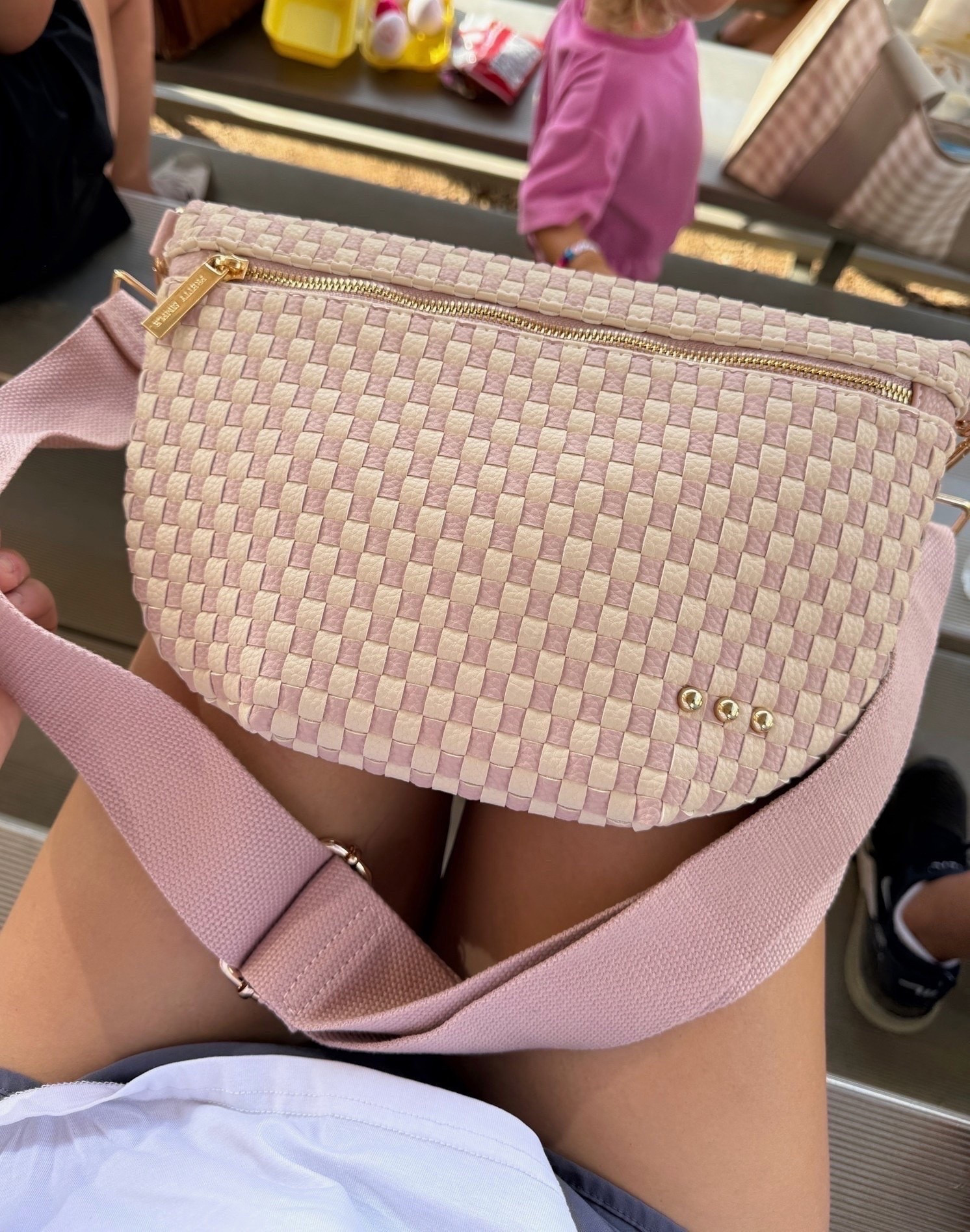 Sports moms, THIS is the bag you need for those never-ending game days!! 👏 Snacks, phone, keys, lip gloss, and all the random things your kids hand you. It holds SO much and keeps your hands free!

sports mom bag, mom essentials, crossbody bag, game day bag, woven crossbody, hands free bag, busy mom essentials, everyday purse, soccer mom outfit, baseball mom essentials, mom on the go, JulieFranks