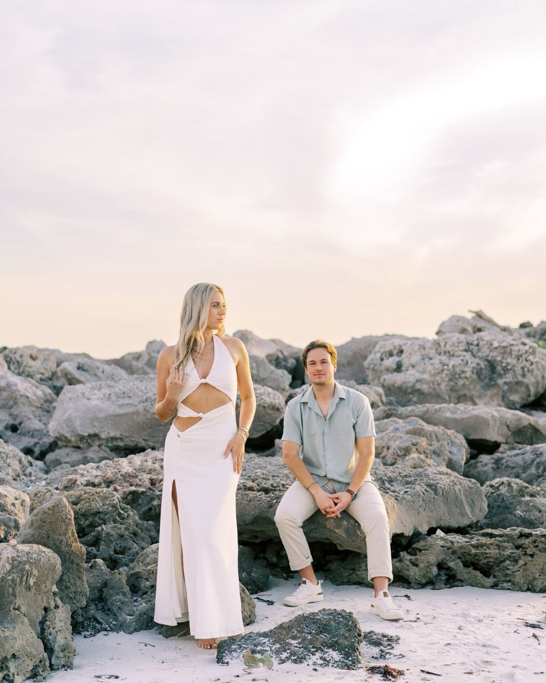 Can we talk about how much location + outfit matter for your proposal photos? 👀

These Naples rocks + Liz’s white cut-out dress = instant contrast, movement, and that editorial feel everyone wants.

You don’t need a full setup to make your proposal feel elevated—you just need the right pieces working together.

This one? Absolute fire. 🔥 Liz and Travis brought the style and the love, and I am obsessed with this proposal. 

Engagement pictures - engagement dress / vacation beach dress 
