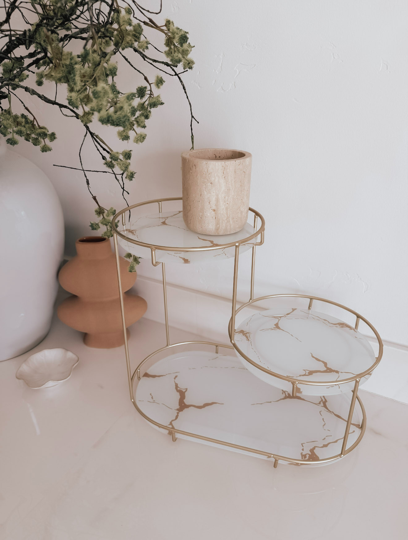 A multi-tiered makeup storage rack feels like a blend of vanity organizer and display piece. Both functional and a little glamorous. it transforms a scattered assortment of products into something orderly and visually pleasing. It’s not just storage, it’s a small stage for the items you use most, framed in gold and always within reach.
 

 #LTKselfcare #LTKBeauty