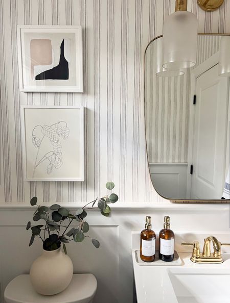 A small powder room but big on style! Add wallpaper to all of the walls, art (just like you would any other room), and accessories (thing flowers or a plant, a pretty tray, and gorgeous soap dispensers to elevate the space). Think of the mirror and sconce(s) as jewelry on top! 