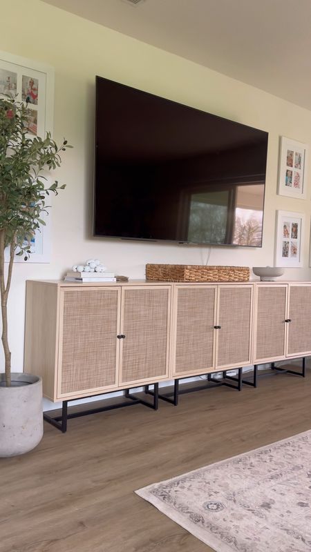 Need a 95” tv console? Tv media wall cabinet? These Amazon rattan cane cabinets are perfect! My wall frames, rug, olive tree

#LTKVideo #LTKhome #LTKSpringSale