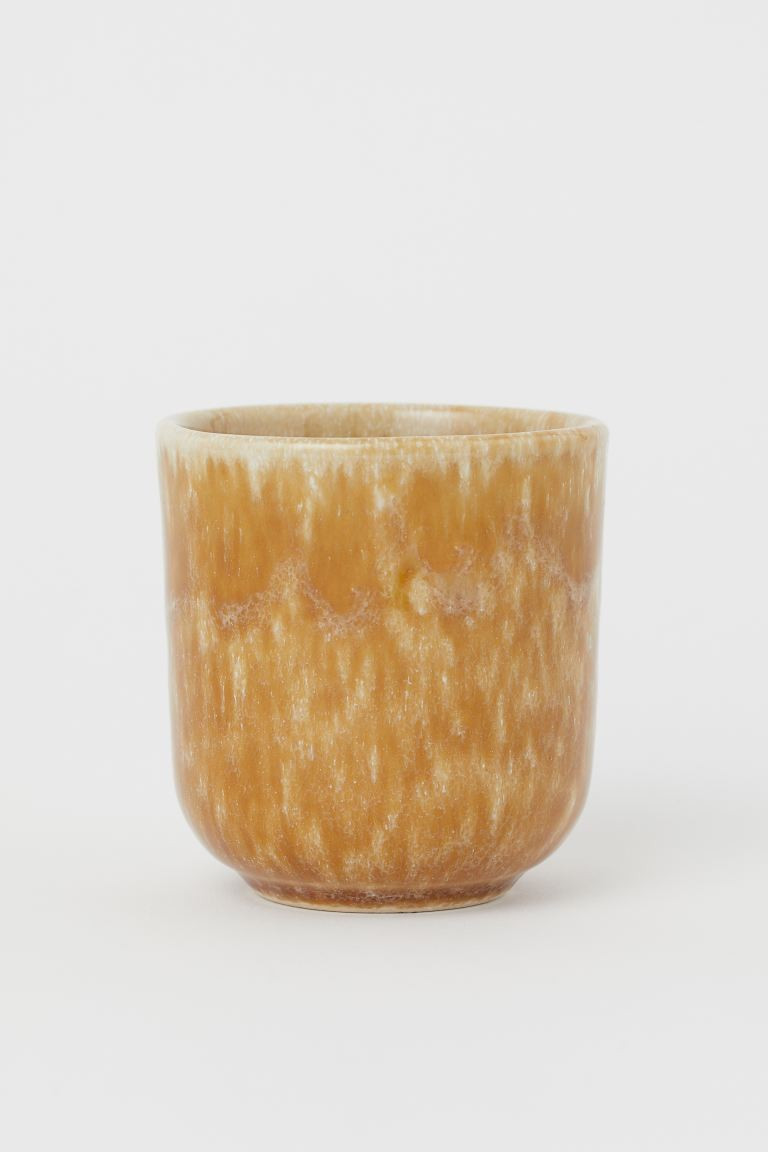 Small mug in glazed ceramic with a speckled pattern. Asymmetric edge. Height 3 in., diameter at t... | H&M (US + CA)