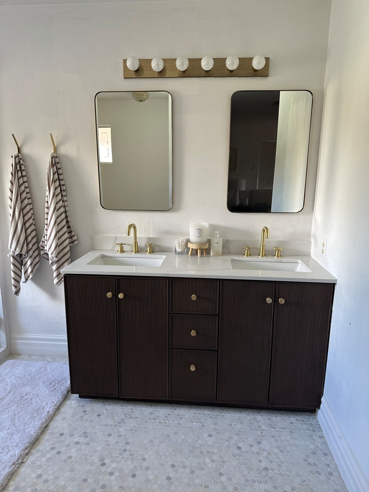 Dark brown vanity with quartz top but we recently replaced the top with a new stone. It ties the whole bathroom togetherr

#LTKHome