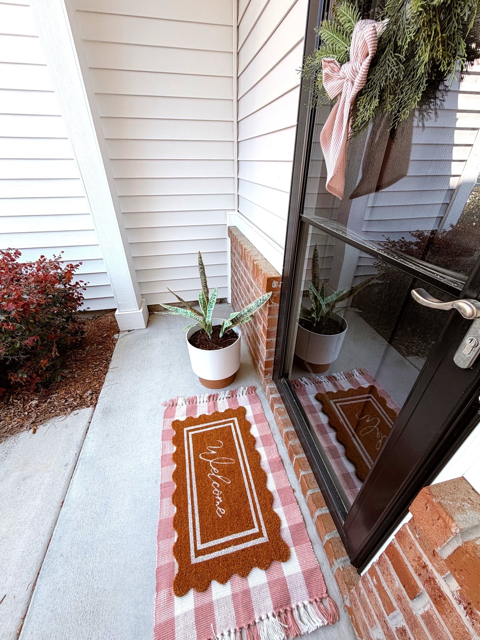 easy and affordable spring front porch refresh under $30 🤍 layered outdoor rugs + a scalloped welcome mat + simple wreath and bow = instant curb appeal without the price tag. 

Reusing a wreathe from Christmas by adding a new gingham bow to it & have had the UV snake plant & planter for years! 

spring porch decor affordable porch refresh layered doormat outdoor rug pink gingham rug scalloped welcome mat front porch ideas budget home decor spring entryway coastal porch decor grandmillennial style walmart amazon my texas house uv artificial plant uv snake plant restyling 

#LTKdayinmylife #LTKSeasonal #LTKHome