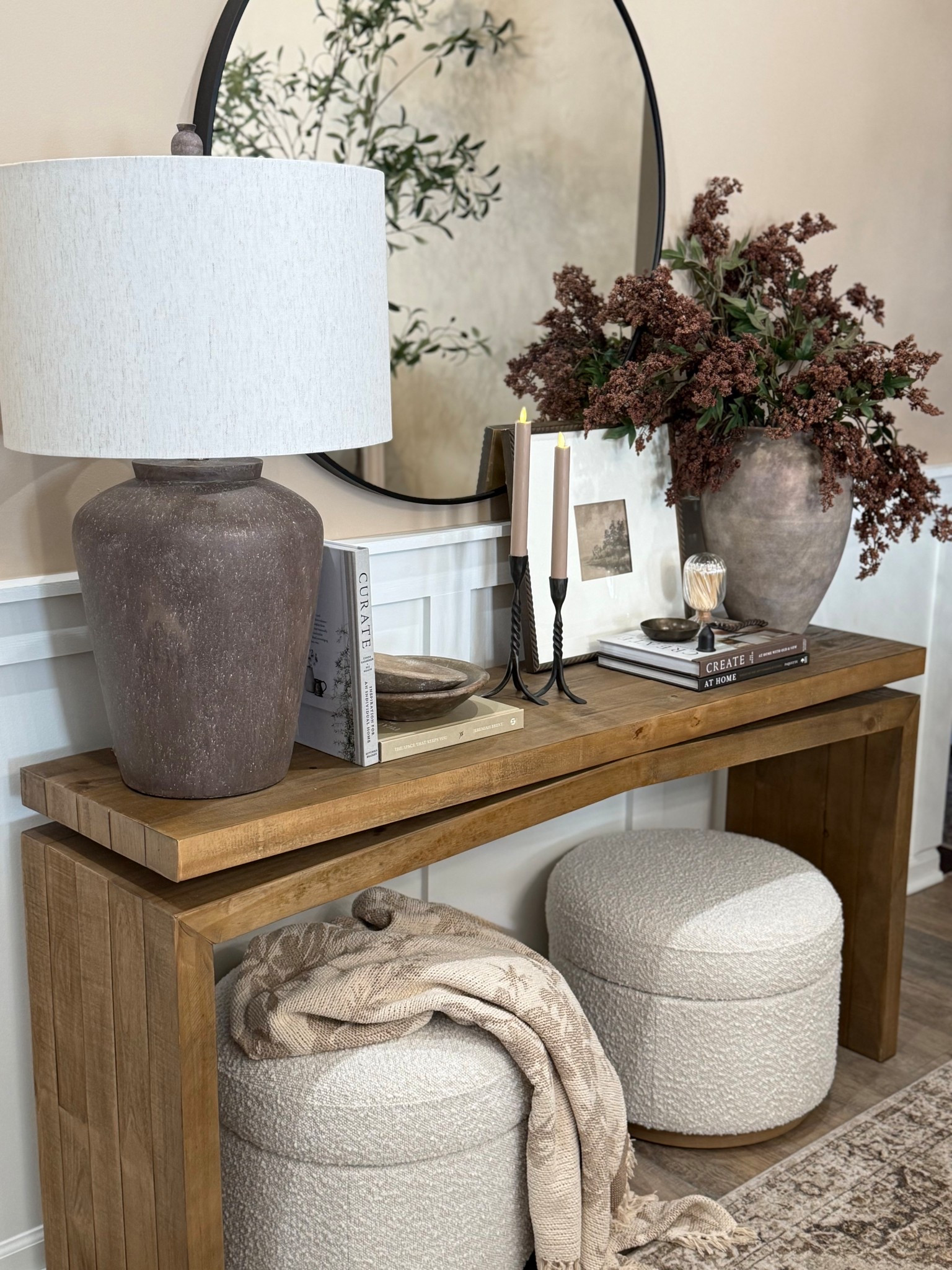 Neutral Console Table Styling with Mirror & Decor

Follow @farmtotablecreations on Instagram for more home styling and decor finds.

A console table is one of my favorite spots to add layered decor that makes a space feel finished. The large round mirror helps reflect light and create height, while simple pieces like a lamp, framed artwork, candles, and a vase with greenery add warmth and balance. Tucking textured ottomans underneath keeps the area functional while adding another cozy layer to the room.

#consoletable #consoletabledecor #livingroomdecor #vasedecor #candlesticks #tablelamp #ottomans #neutraldecor #livingroomfurniture

#LTKHome #LTKSaleAlert
