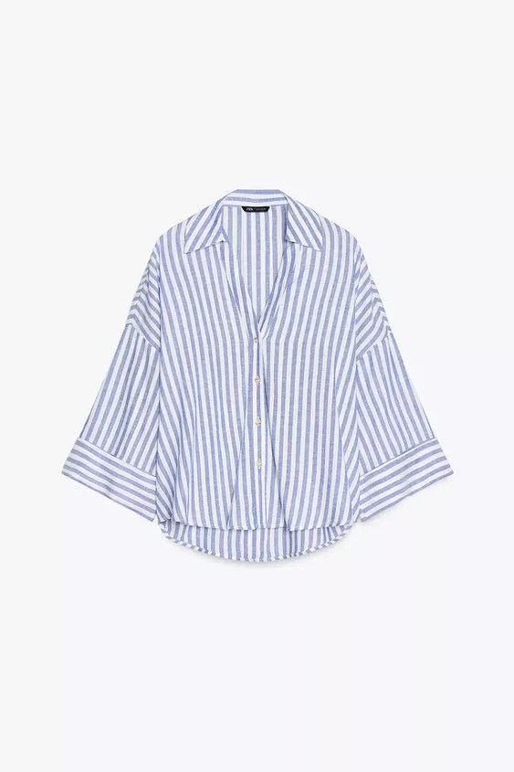 Shirt made with linen. V-neck lapel collar and wide turned-up sleeves. Asymmetric hem. Front butt... | Zara US