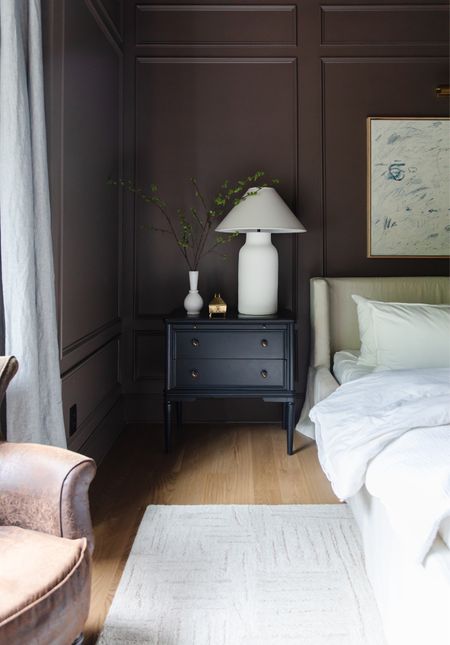 Moody Modern Traditional Primary Bedroom 🖤

Black nightstand, leather chair, white bedding, picture light, upholstered slipcovered linen bed, area rugg

#LTKhome #LTKSeasonal