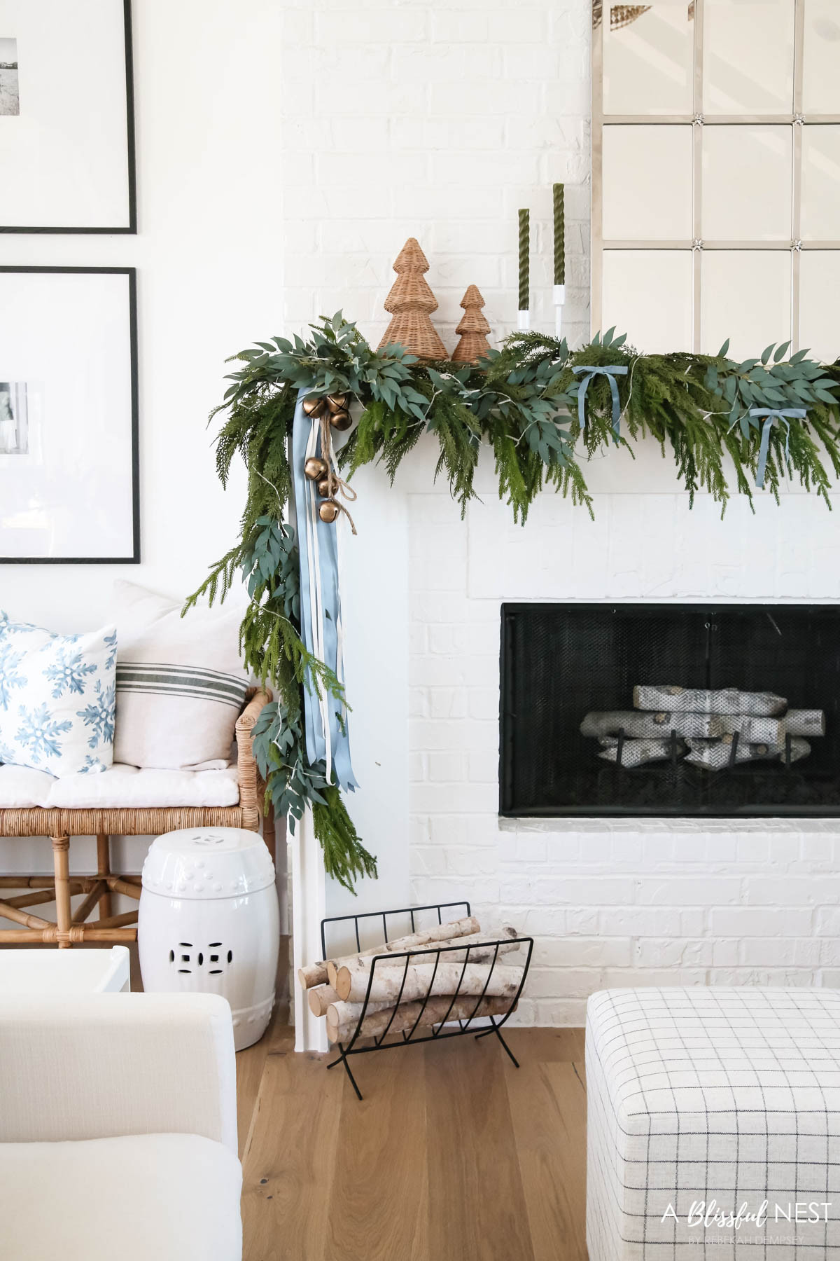 A few layered textures go a long way in creating a cozy moment. Tap to shop for everything.
blue velvet bows, woven Christmas cone tree, Norfolk pine Christmas garland, olive green taper candles, candlestick holders, dusty blue satin ribbon, ivory velvet ribbon, vintage cluster cow bells on rope, fairy lights, snowflakes throw pillow, striped pillow, upholstered cube ottoman, rattan bench, decorative birch log, metal birch log holder 

 #LTKHoliday #LTKSeasonal #LTKHome