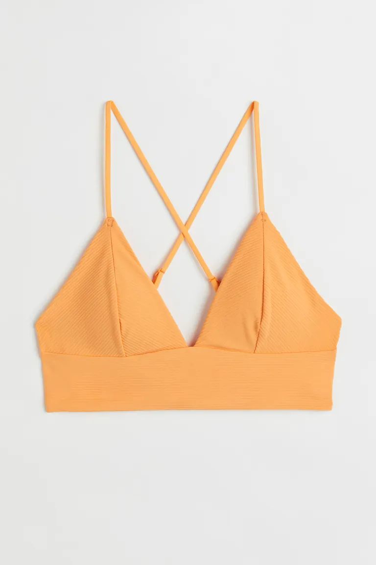 Conscious choice  Lined, soft-cup bikini top. Narrow, adjustable shoulder straps crossed at back,... | H&M (US)