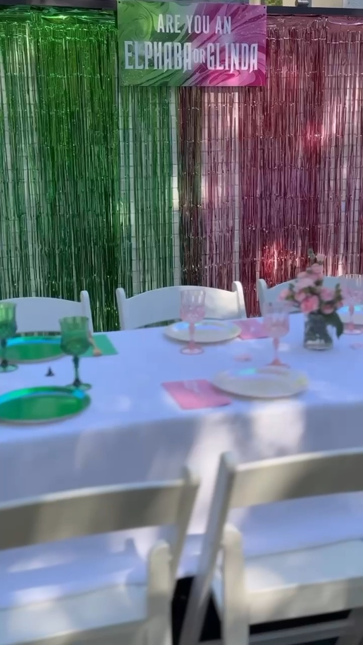 ARE YOU AN ELPHABA OR GLINDA 💚🩷
   
Yesterday we transformed Lauren’s backyard into the most POPULAR party for Cara + Sienna’s 9th birthday. What a Wicked scene!
   
What were the highlights? The
Elphaba vs Glinda photo op, stunning half green half pink table set up, Elphie’s green elixir, Ga-Linda’s boutique, and our ‘Oz’some karaoke booth. 

#LTKWatchNow #LTKKids #LTKParties