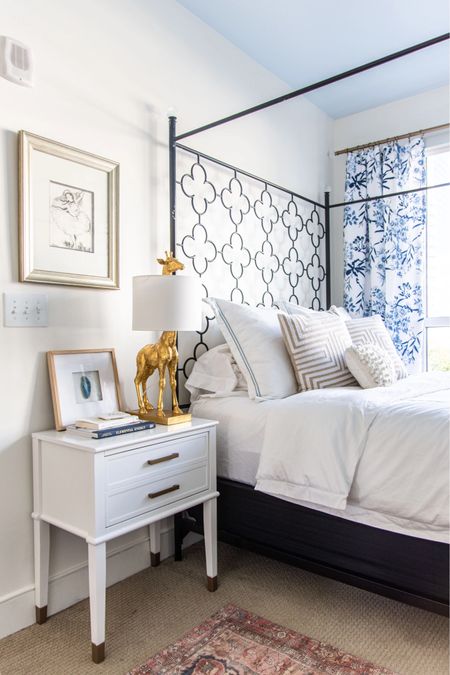 Roundup of affordable white nightstands with drawers from this bright blue and white bedroom design with a metal canopy four poster bed and floral curtains 

#LTKhome #LTKsalealert #LTKstyletip