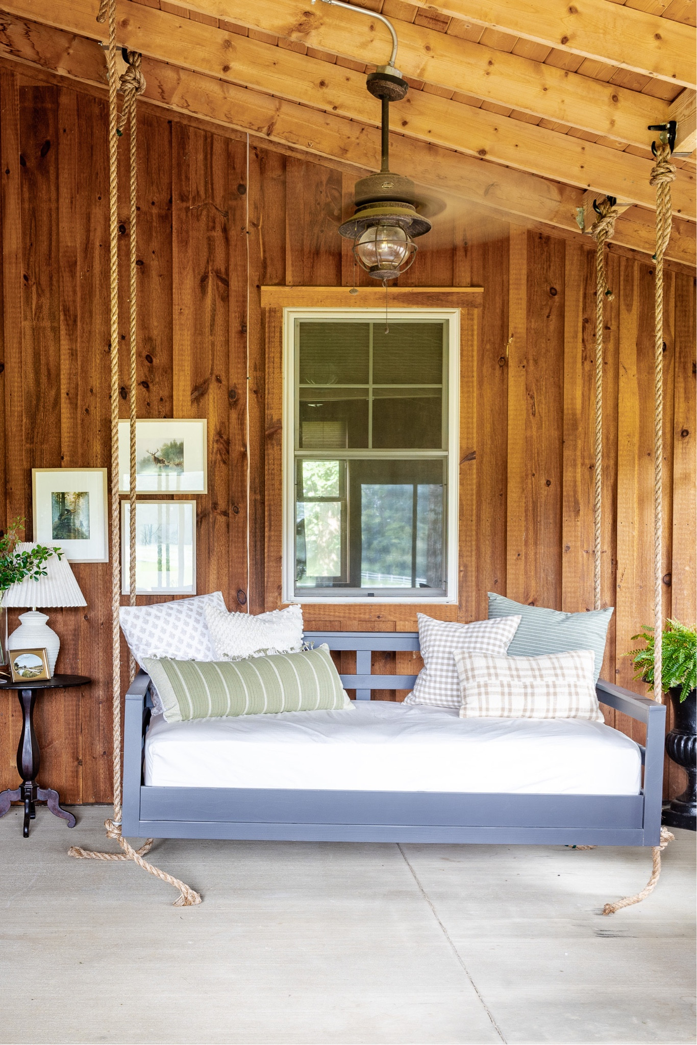 Barndomium screened in porch patio swing bed. Vintage art, swing bed, throw pillows, fall decor 

#LTKFind #LTKSeasonal #LTKhome