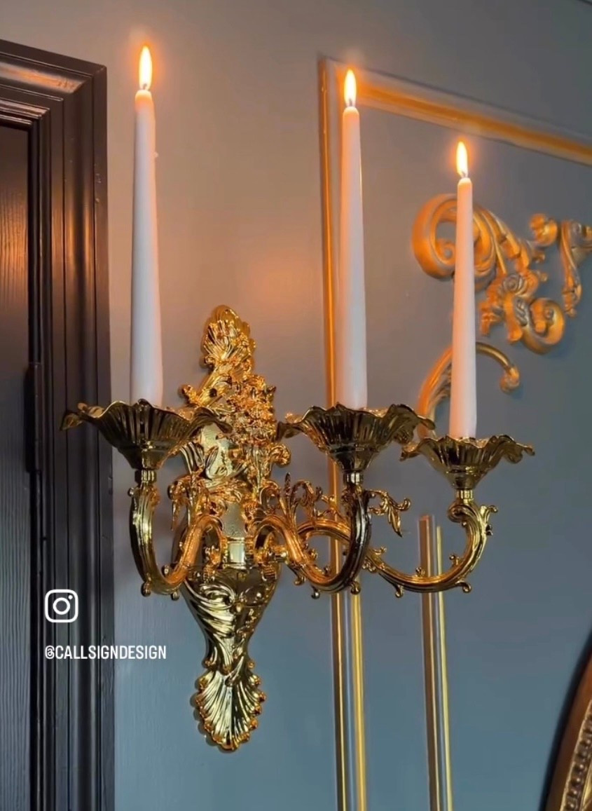 An ornate gold wall candelabra that brings instant drama and old world romance to the space. Sculptural, glowing, and timeless, it turns any wall into a moment. 🕯️✨ 

#GoldCandelabra #WallDecor #OldWorldCharm #MoodyInteriors #StatementPieces #HomeDecor #DesignDetails #callsigndesign