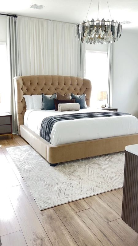 Shop our gorgeous modern bedroom furniture 💕Modern tufted headboard bed, grey & brown nightstands, cream area rug (8x10), marble top brown 6 drawer dresser, grand  arch mirror, side table, camel accent chairs, and stunning contemporary lamp. 

#LTKhome #LTKU #LTKFind