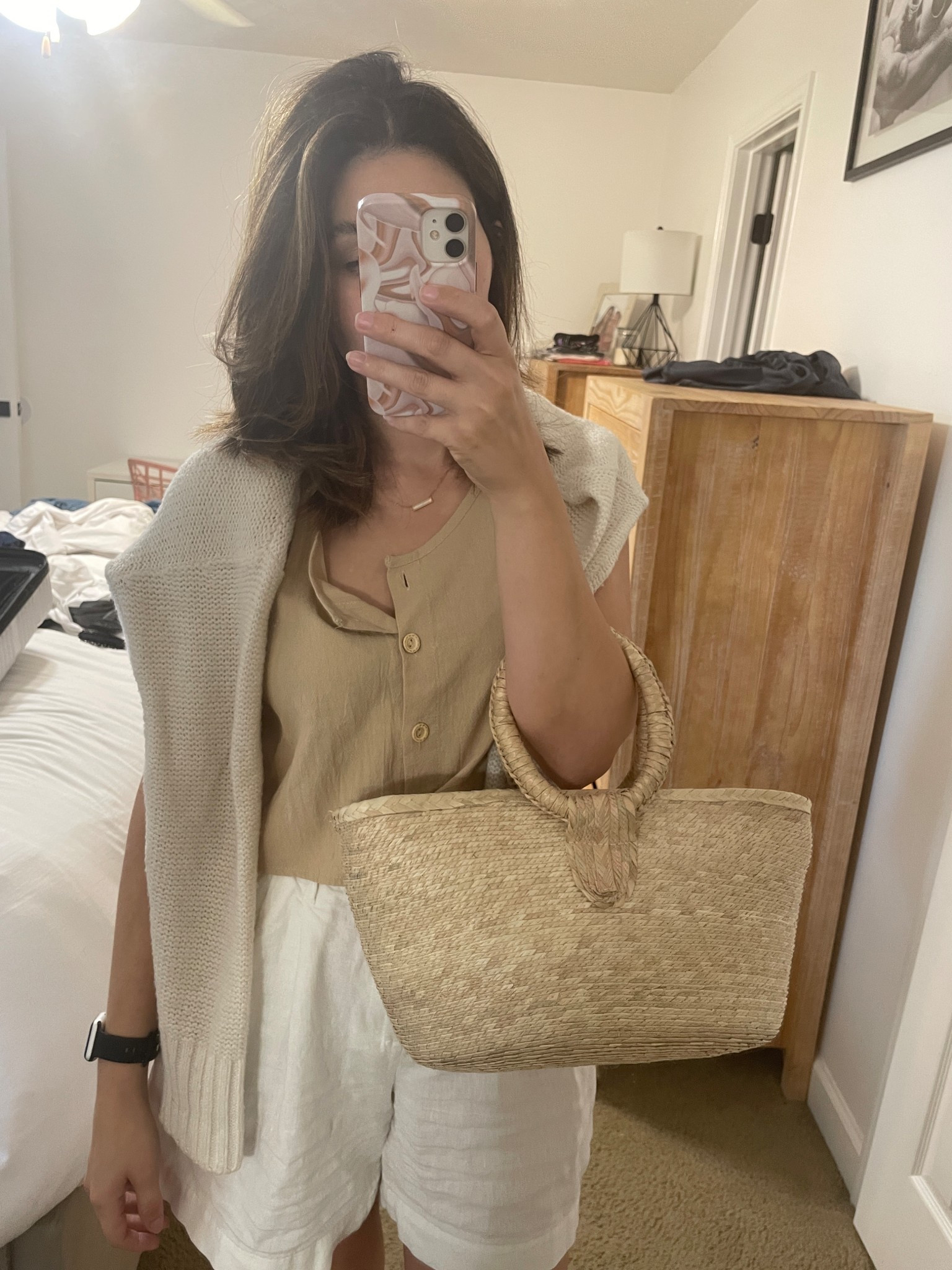 Casual Summer outfit with shorts. I am wearing a tan cropped vest from Shien in a size medium, white linen shorts from Target in a size 4, a cream colored cable knit sweater, a straw purse and black watch band. #summer #ltksummer #style #summerstyle #shorts #ltkshorts #summerfashion #fashion #casual #casualfashion  

 #LTKSummerEdit #LTKSeasonal #LTKFindsUnder50