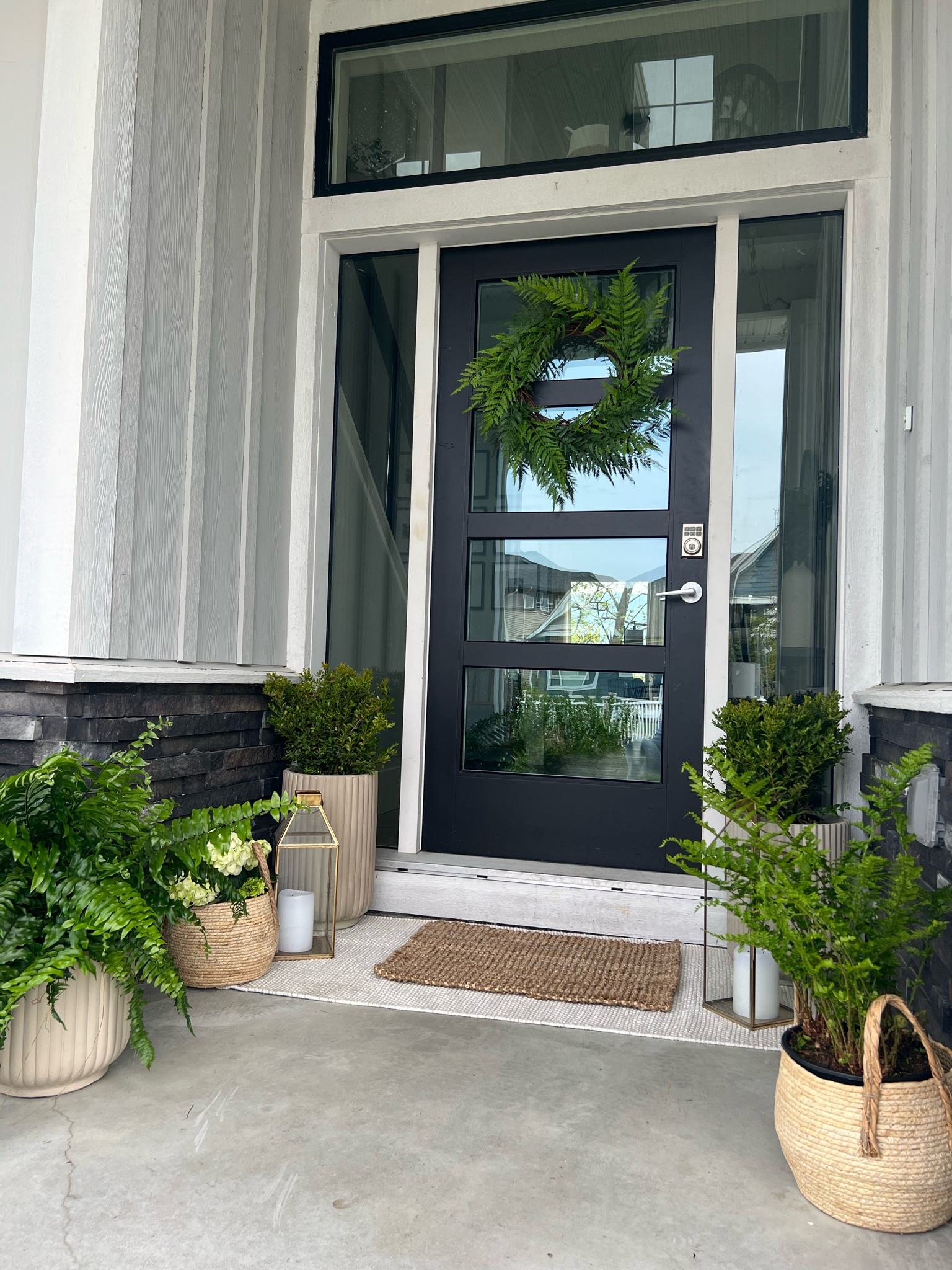 My Spring porch! Neutral layered rugs.. boxwood and ferns in cement planters and baskets! 