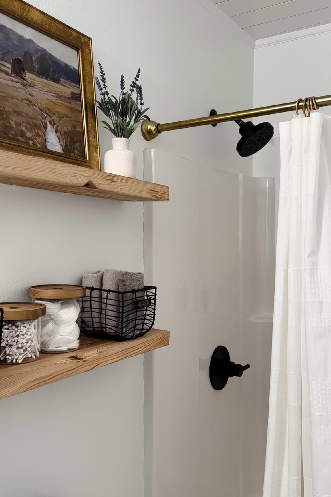 Bathroom renovation, bathroom decor, delta matte black shower faucet, wood bathroom shelves, brass shower curtain rod, bathroom shelfie, bathroom storage, white shower curtain, bathroom art, target finds, studio McGee, hearth and hand 

#LTKstyletip #LTKhome