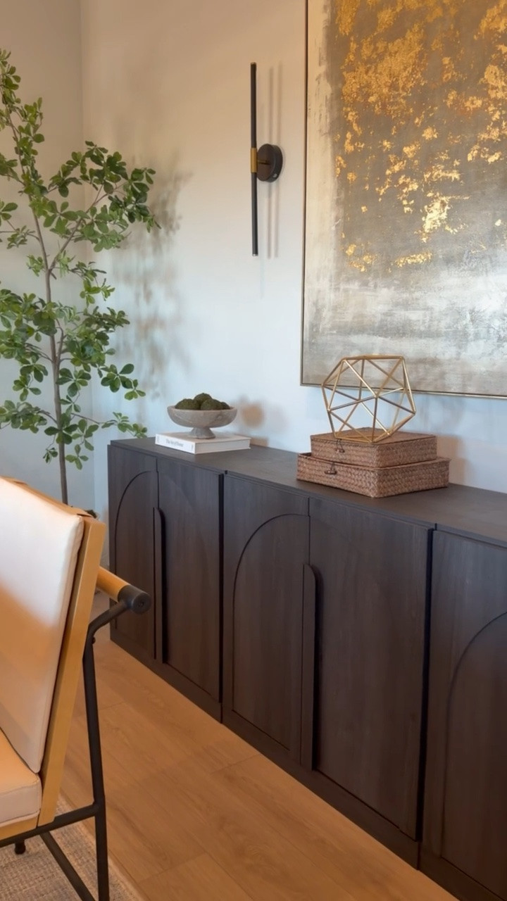 This space shows how a few well-chosen pieces can make a room feel warm, collected, and elevated. The dark wood console, oversized artwork, woven boxes, sculptural accents, and natural greenery all work together without feeling overdone.

I linked some of the pieces to recreate this warm, modern organic look at home.
@Wayfair 
@Target 
@Amazon

#LTKSaleAlert #LTKU #LTKHome