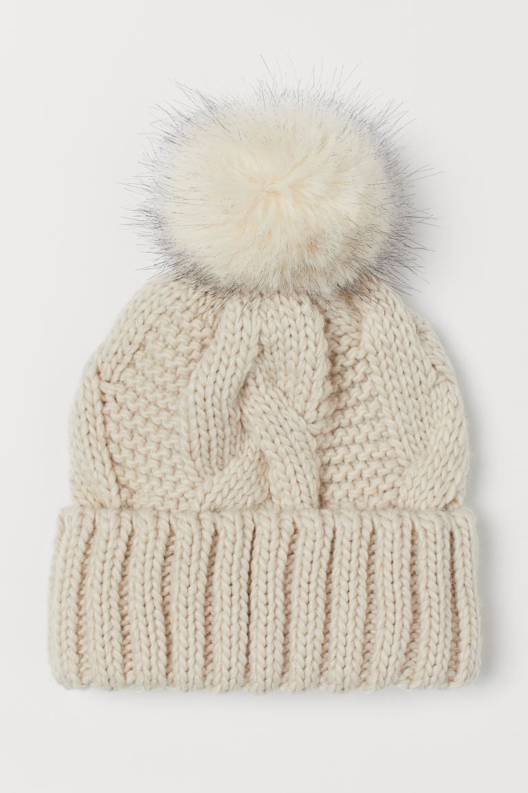 Soft, cable-knit hat with a faux fur pompom at top. Sewn, foldover cuff. | H&M (US + CA)