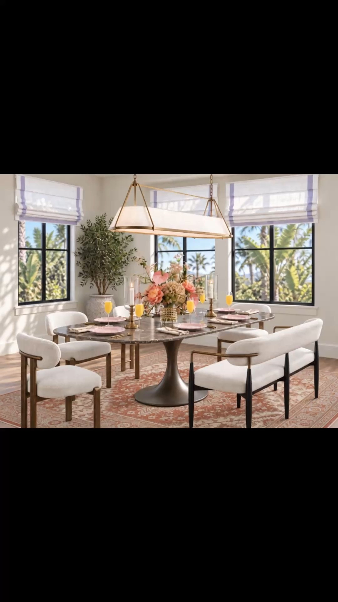 Sunday brunch at home with a dining space that feels warm, layered, and timeless. I love the rich chocolate-brown marble dining table paired with its sculptural warm metal base—the deeper stone tone gives the room so much character without feeling heavy. The patterned rug brings softness and warmth underfoot, while the upholstered dining chairs and bench keep everything relaxed and inviting. A modern-classic chandelier adds just the right touch of old-world charm while still feeling clean and current. Finished with tailored Roman shades, a fresh flower arrangement, pink dinner plates, woven placemats, fluted champagne glasses, hurricanes, and an easy Sunday tablescape made for lingering a little longer.

Up to 50% off at Arhaus now.

#SundayBrunch #DiningRoom #DiningTable #MarbleDiningTable #DiningChair #DiningBench #AreaRug #Chandelier #RomanShade #FlowerArrangement #Tablescape #Tabletop #Dinnerware #Placemat #ChampagneGlasses #HurricaneCandleHolder #ModernClassic #DiningRoomInspiration

#LTKdayinmylife #LTKHome #LTKSaleAlert