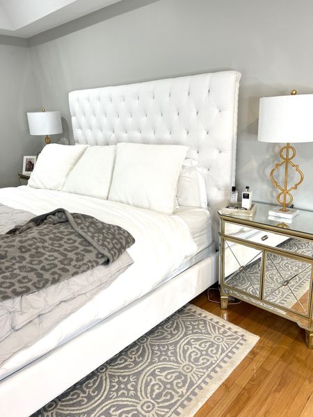 White tufted headboard, mirrored night stand, gold lamp 

#LTKhome
