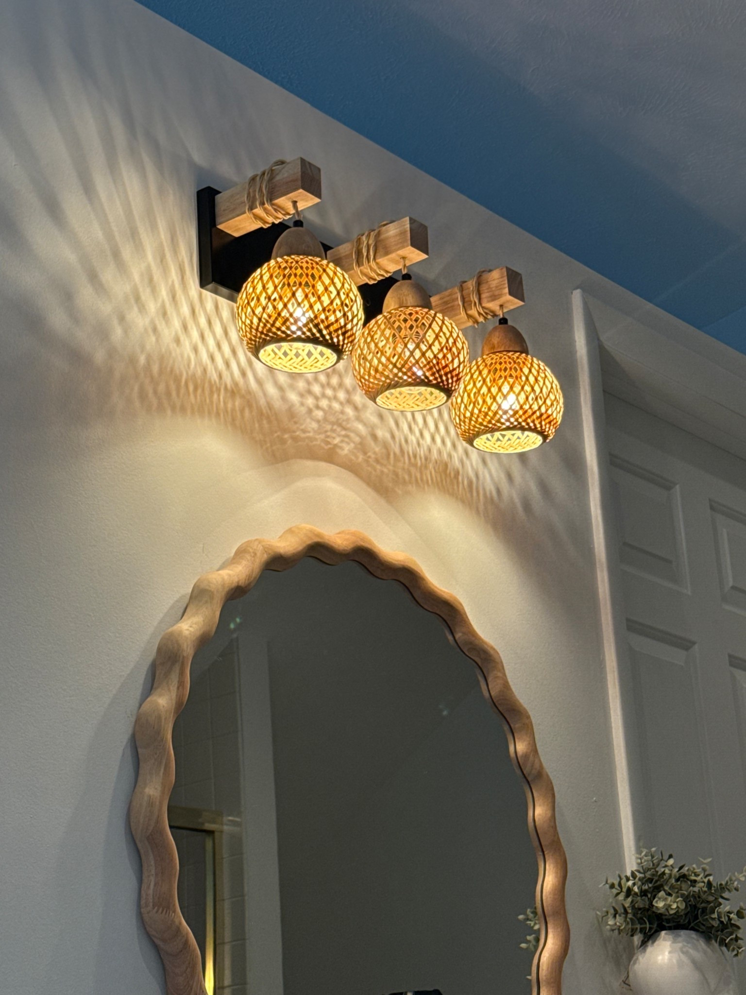 Finding a beachy, rattan-inspired vanity light was harder than expected, especially one that didn’t require mudding and patching drywall underneath 🙃

This fixture was the win. It comes in 3–5 light options and the backplate is large enough to cover a multitude of sins (aka old holes, paint lines, and past decisions 😂).

It gives that warm, boho, coastal feel without looking unfinished. 

+ And the mirror adds a driftwood-inspired beach touch while still feeling polished and intentional.

Linked here 🤍

#LTKHome