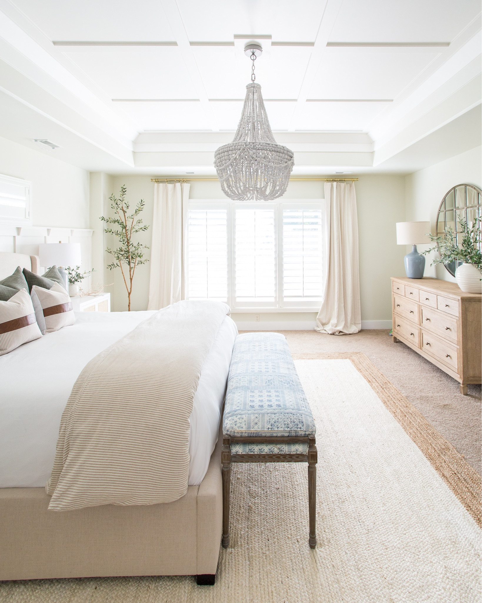 Our master bedroom decorated for fall! Items include a striped duvet, faux leather pillows, linen pillows, a blue glass table lamp, a white nightstand with rattan cane doors, a wood beaded chandelier and a white jute rug.  Other items include a blue and white batik upholstered bench, a light wood dresser, a white vase with faux greenery, a round metal wall mirror, a faux olive tree and striped linen curtains. 

simple decor, home decor, neutral décor, neutral decorating, amazon neutral décor, neutral home décor, neutral pillows, neutral target, coastal décor, coastal decorating, master bedroom decor, targetfanatic, target style, target bed, amazon home, amazon finds, walmart home, bedroom bedding, long size bed, pottery barn bedding, pottery barn décor, pottery barn inspired bedroom, bedroom rugs, guest bedroom decor, studio mcgee, target finds, target home, bedroom rugs on carpet, rugs usa, pottery barn mirrors, pottery barn master bedroom, master bedroom inspiration, guest bedroom inspo, bedroom benches, coastal design, master bedroom, coastal bedroom, simple decorating, bedroom decorating #ltkfamily #LTKSeasonal #LTKunder50 #LTKunder100 #LTKsalealert #LTKhome #LTKstyletip

#LTKhome #LTKSeasonal #LTKfamily