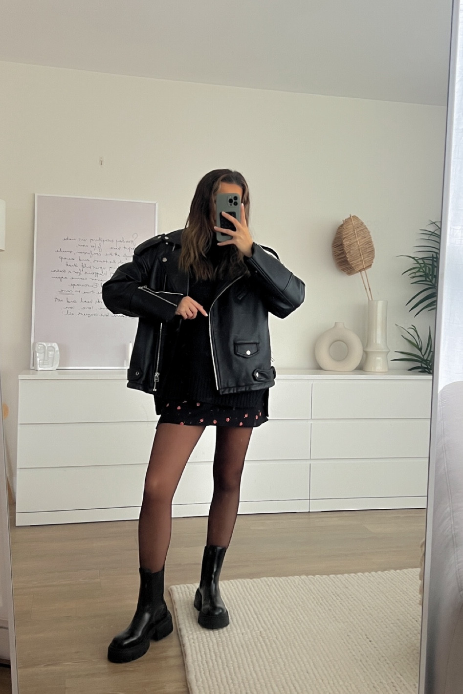 Oversized leather jacket with Abercrombie tuckable jumper, floral skirt and 15 denier tights with chunky boots 

