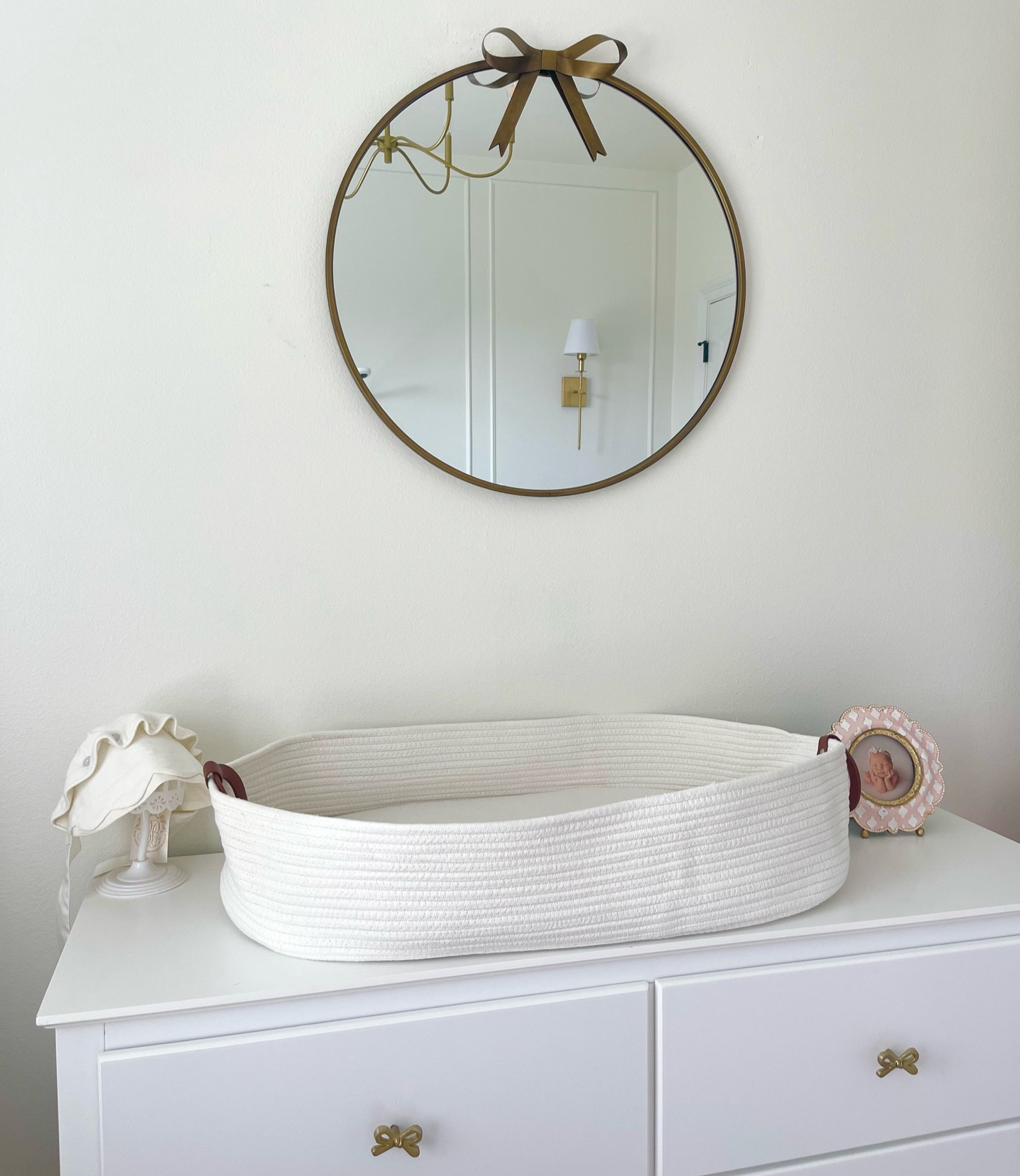 Baby girl nursery, pink gold white, bows, gold bow mirror, battery gold wall lights, decor 

#LTKBaby #LTKHome #LTKFindsUnder50