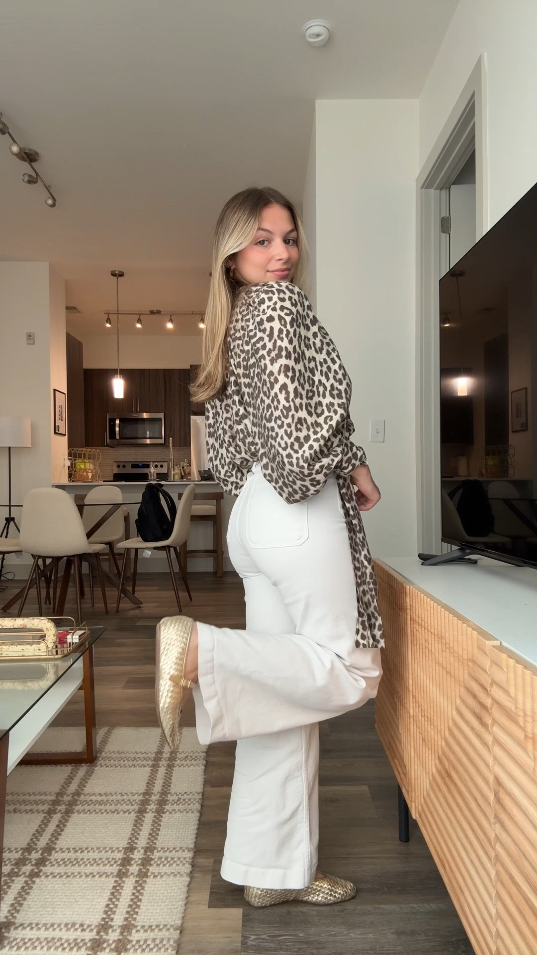 Neutral layers, but make it bold. Styled a leopard print wrap blouse with white wide-leg jeans for a chic everyday look. Perfect for work, dinner, or weekend plans. Shop my leopard top, high-waisted jeans, and neutral accessories here  