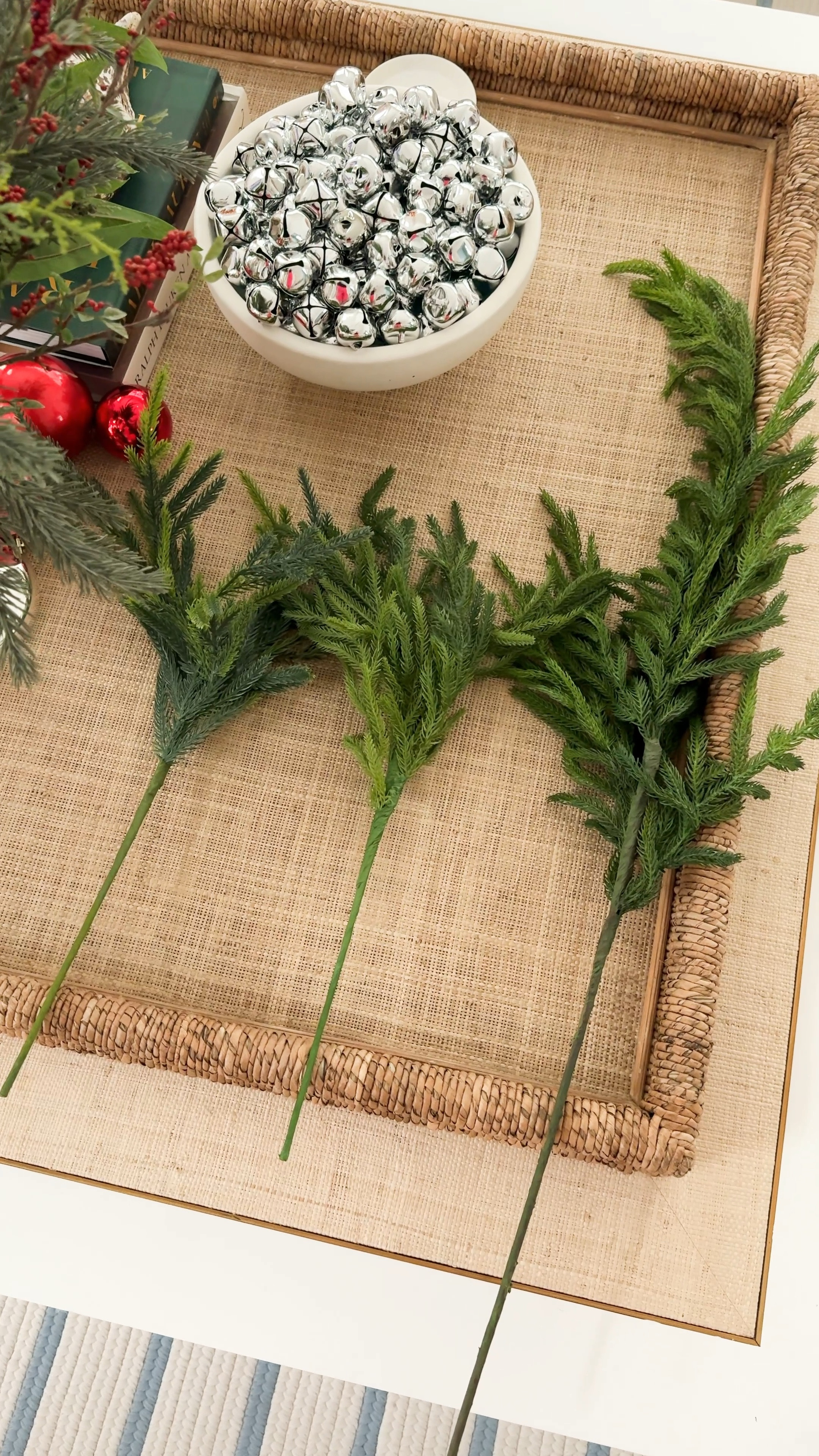 Three different types of Norfolk pine stems! The original viral Afloral option is on the right (two stems are more than the price of 12 of the other options). The middle option (Jutom) is the closest to color and texture, and the left (Whanley) has lighter tips for a slightly different look. They are all real-touch and look beautiful styled in vases! #ltkholiday #ltkhome #ltkfindsunder50 #ltksalealert #ltkfindsunder100 #ltkseasonal #ltkstyletip #ltkvideo silver jingle bells, red ornaments, raffia tray, classic Christmas decor 

#LTKVideo #LTKHome #LTKHoliday