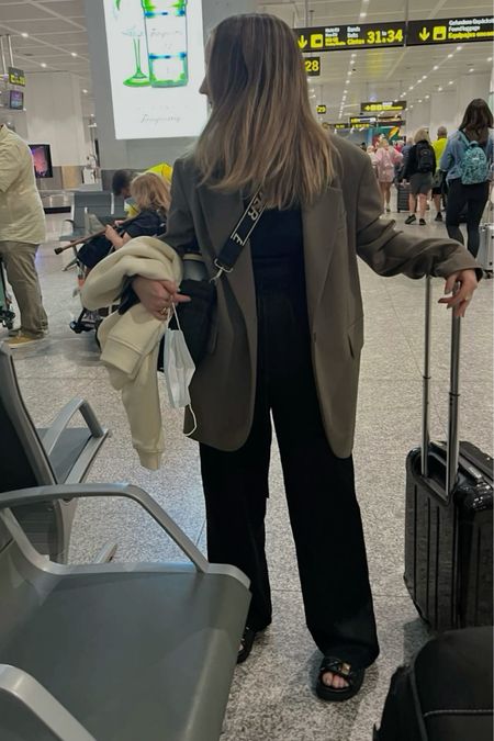 I love this airport outfit formula… loose fitting black trousers, a plain black top, an oversized blazer and a pair of Dad sandals 🖤
Airport outfit ideas | Travelling outfit | Holiday outfit | Arket oversized blazer | Black silk trousers | Elasticated trousers | Cross body bag | Linen trousers | Pull on trousers | Skims trousers | black suitcase cabin bag 

#LTKeurope #LTKtravel #LTKsummer