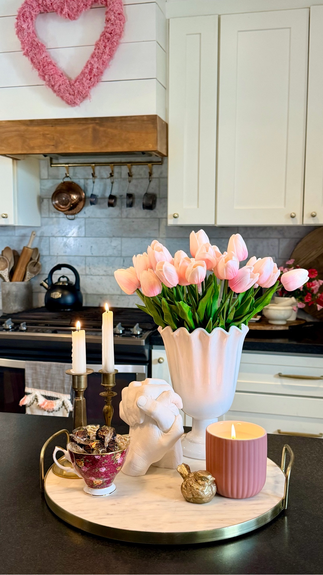 Sentimental Valentine’s Day Kitchen Centerpiece! 
💐💐💐
I styled a marble tray with faux tulips that look and feel real, cozy candles, a vintage Royal Albert teacup from my mom filled with truffles, and a vintage gold bird accent. The hand sculpture is of my husband’s and my hands and was made using a hand casting kit! It’s one of my FAVORITE meaningful decor pieces and would make a beautiful Valentine’s gift idea for a lasting keepsake you can display year round.

#valentines #valentinesday #vday #valentinesdecor #valentinesdaydecor #valentinesideas #happyvalentinesday #centerpiece #valentinesvignette
