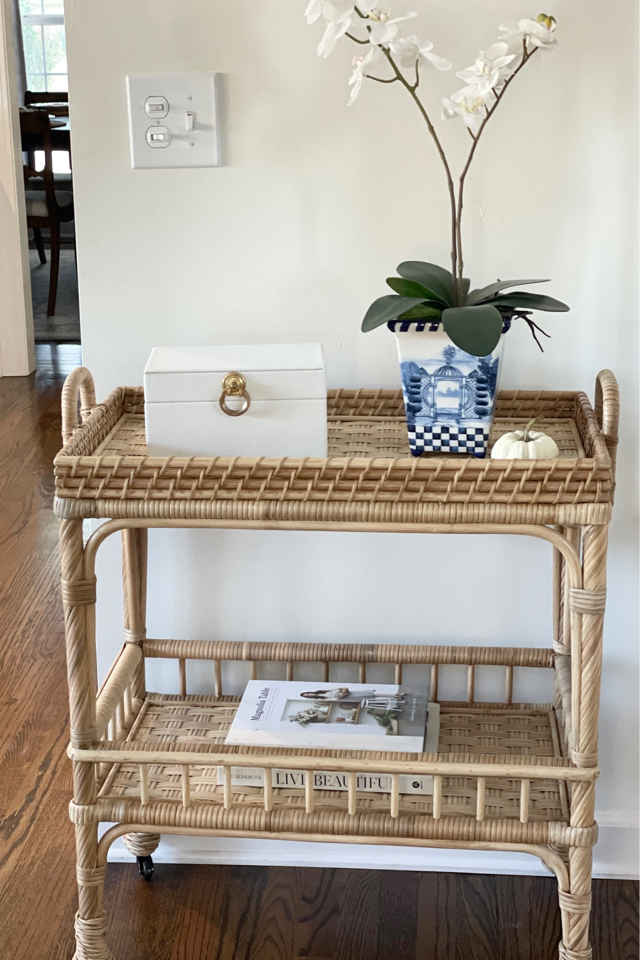 Serena and Lily side cart. Rattan bar cart. White decorative pumpkin. Live Beautiful coffee table book. Magnolia table book. Blue and white vase with faux orchid. White faux pebbles leather decorative box.

#LTKhome