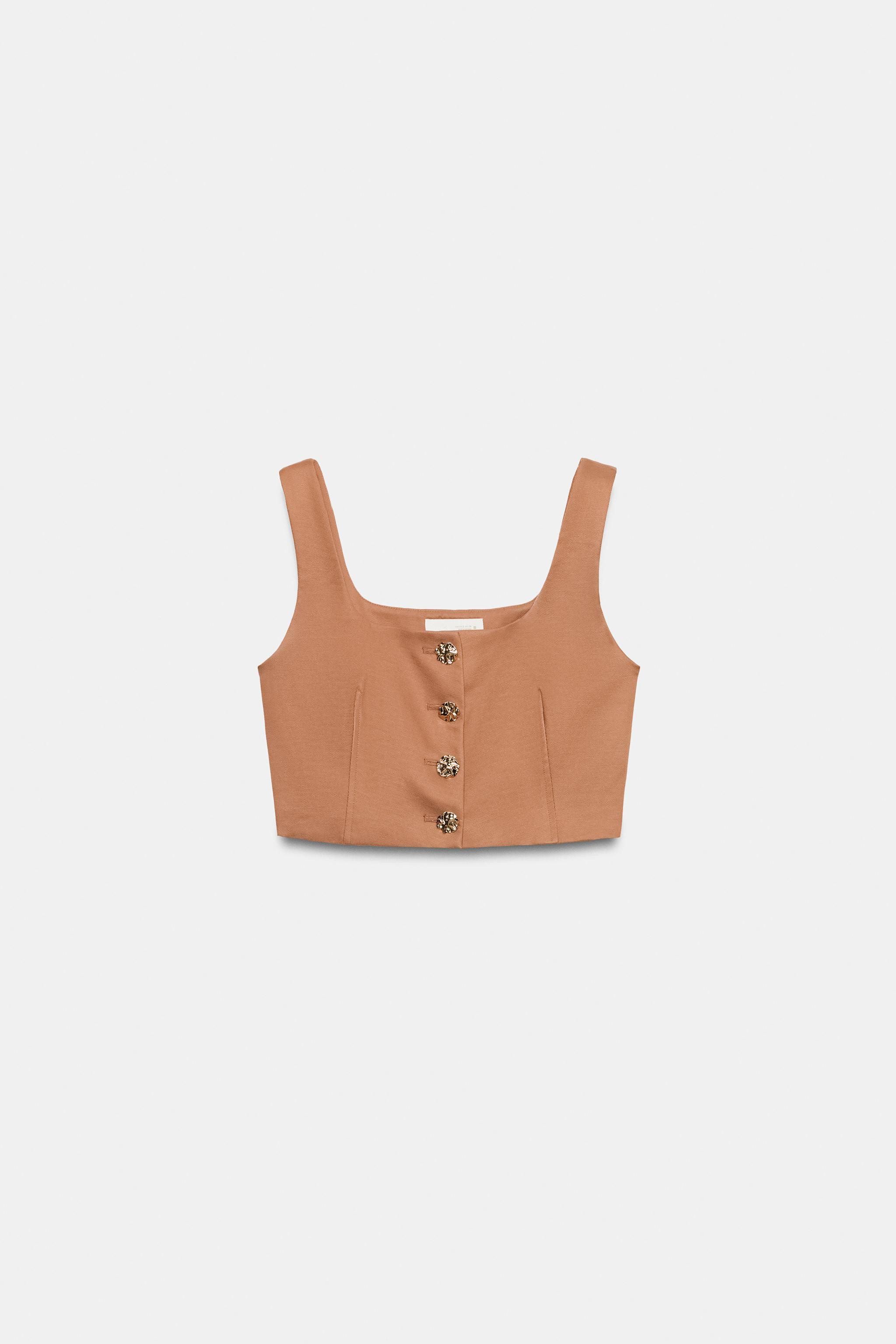 Model height: 183 cmStraight neckline vest with wide straps. Front closure with embossed gold but... | Zara US