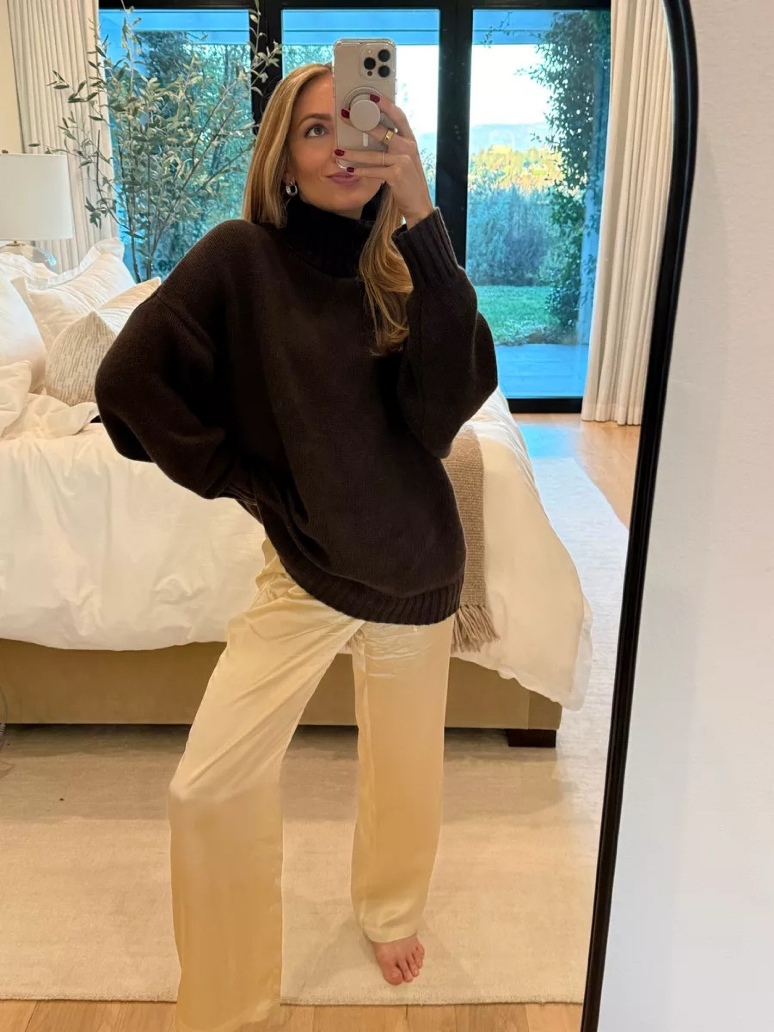 Coziest winter look I wear at home and also out to dinner - the ivory silky pants are a winter closet staple to dress up or down. Paired them with this cozy brown Jenni Kayne turtleneck sweater ❄️ Sizes worn here: Turtleneck XS (very oversized!) Pants XS (TTS)

#LTKStyleTip #LTKWatchNow #LTKSeasonal