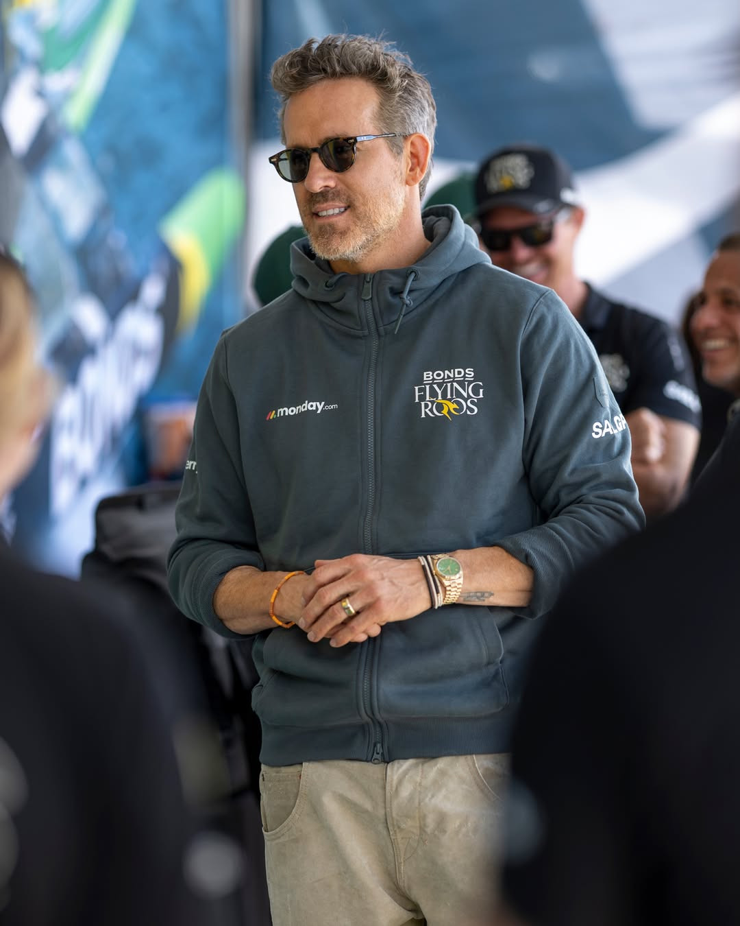 Ryan Reynolds with the Bonds Flying Roos wearing Thom Browne sunglasses, Luis Morias bracelets, and Archie & Dennis army pants 

 #LTKootd #LTKOver40 #LTKMens