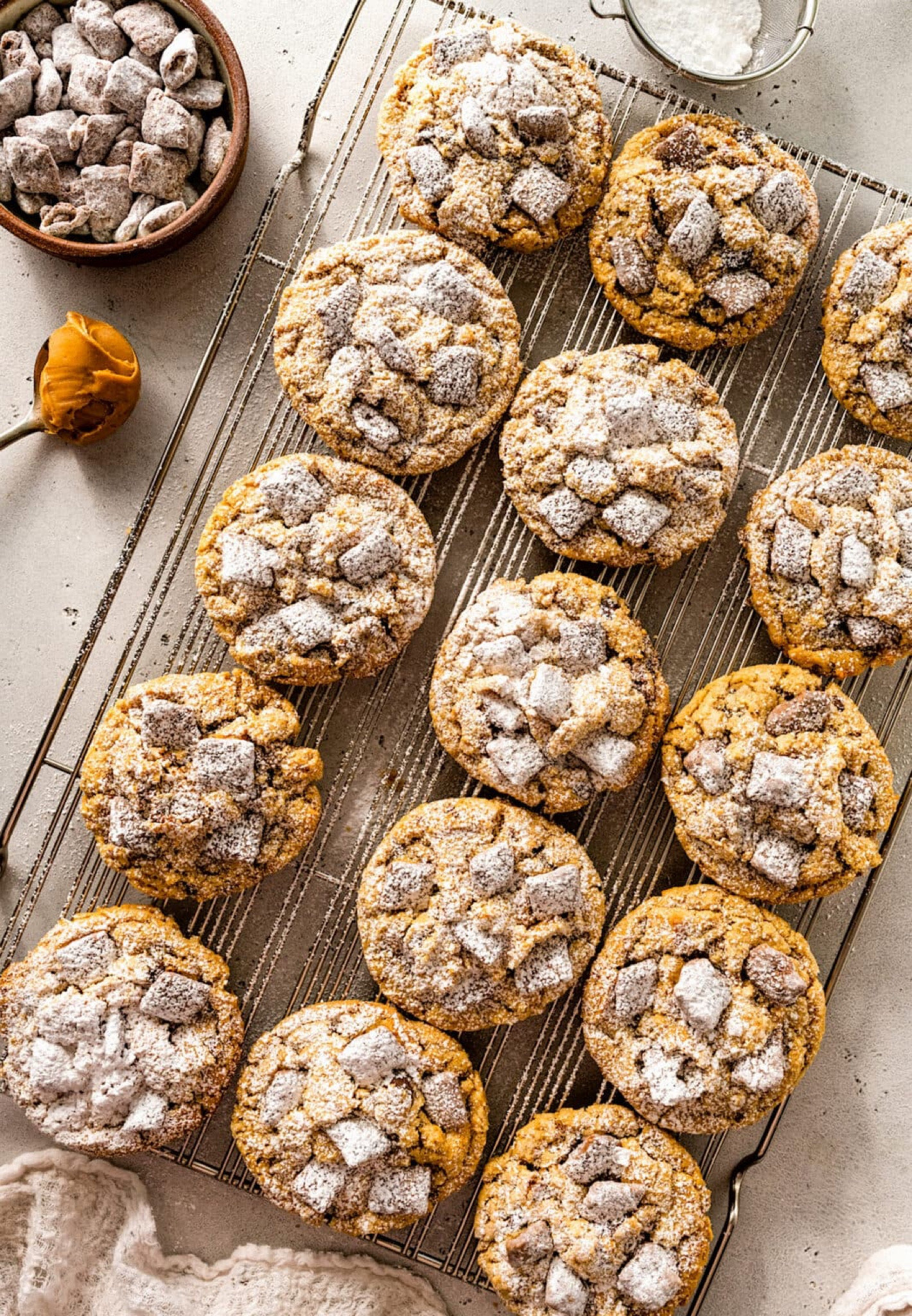 Puppy Chow Cookies- soft peanut butter cookies with sweet and crunchy puppy chow (muddy buddies), chocolate chips, and a dusting of powdered sugar! If you like the famous chocolate peanut butter cereal snack mix, you will LOVE these cookies!

#LTKFindsUnder50 #LTKHome #LTKSeasonal