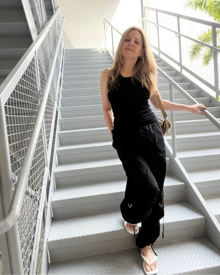 One of my go to everyday outfits, it’s comfortable and easy. Just a simple black tank with loose fitting parachute cargo pants and my puffy flip flops. Sometimes I wear white sneakers or layer a sweatshirt or denim jacket if it’s cooler outside. 

#LTKstyletip #LTKover40 #LTKsalealert