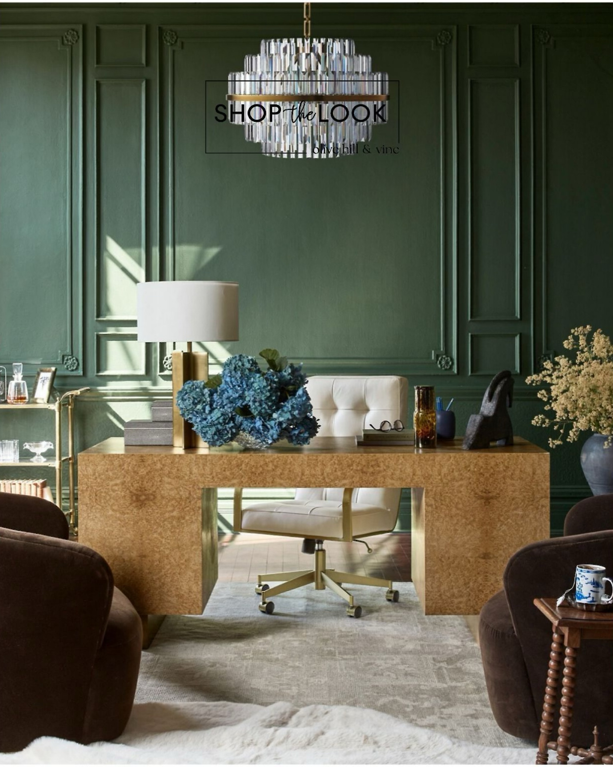 Embrace sophistication with this lush deep green wall, exuding creativity and calm. Elevate your workspace with a sleek bar cart for spontaneous brainstorming sessions. Swivel armchairs offer flexibility, while the upholstered desk chair adds comfort and style. Illuminate your tasks with a unique x brass-metal lamp, complementing the burlwood desk. Complete the ambiance with a dazzling round crystal chandelier, sparking inspiration at every turn! 

#LTKstyletip #LTKhome #LTKfamily