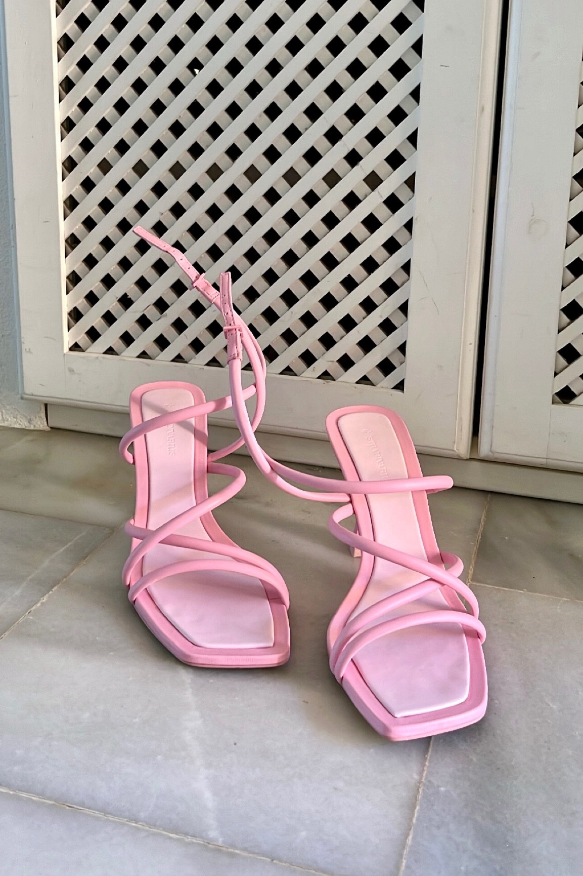 Pink strappy heels. Fashion Blogger Girl by Style Blog Heartfelt Hunt. Girl showing her pink strappy heels.