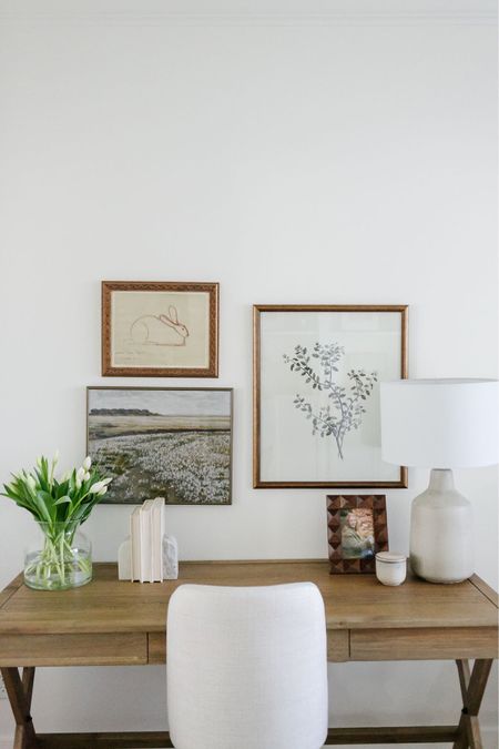 In my home office I have a wood campaign desk from World Market and an upholstered desk chair from Pottery Barn. On the desk I have a concrete table lamp. Above the desk is a small gallery wall of artwork. 

#LTKFind #LTKhome #LTKsalealert