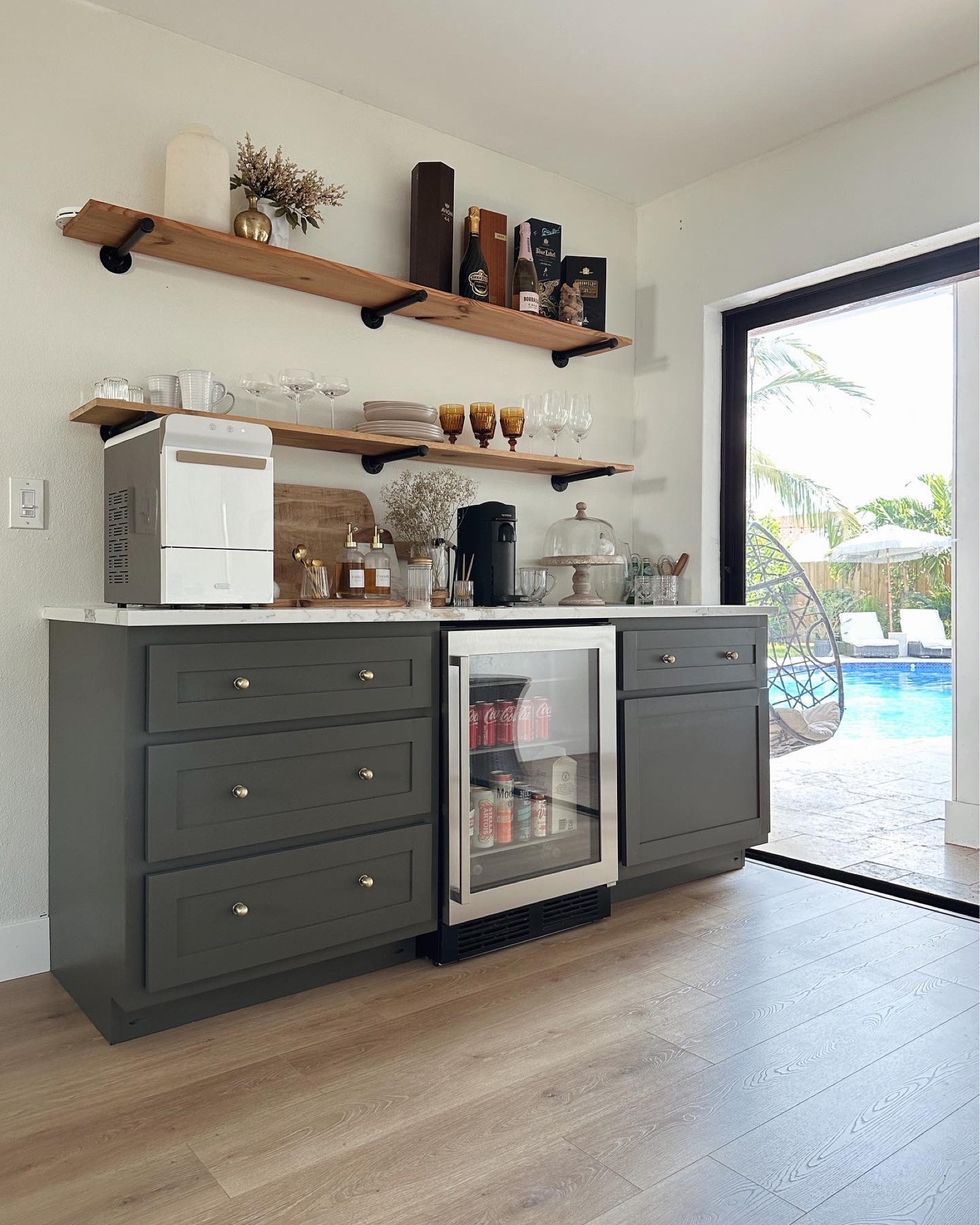 Dry bar Coffee Bar 

New year 
New years 
New Year’s Eve 
Coffee bar 
Home bar 
Coffee 
Organize 
Nespresso 
Coffee machine 
Spoons 
Gold silverware 
Kitchen 
Kitchen cabinets 
Kitchen decor 
Shelf decor 
Open shelves 
Glassware 
Mug 
Coffee mug 
Travel 
Relax 
Cafe 
Appliances 
Bar 
Glasses 
Amazon home
Lowe’s 
Cabinets 
Kitchen 
Kitchen design 
Home bar 
Beverage bar 
Ice maker 
Mini fridge 
Refrigerator 
Dry bar 
Wet bar
DIY bar 
Home bar 
Amazon home 
Lowe’s
Home Depot 
Shelf
Shelves 
Floating shelves 
Cabinet 
Kitchen inspo
Kitchen design 
Pool
Poolside 
Pool design #LTKHoliday 

#LTKswim #LTKhome #LTKfamily