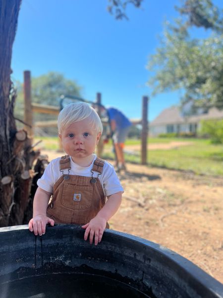 Toddler baby farm boy. Carhartt overalls are the best for outdoor ranch work 🤍  These are size 9 months and we’ve had him in them from 6 months and they still fit at 14 months! My favorite purchase. 

Bib overalls, white tee shirt baby boy, 12 months, mamas boy outfit baby registry item ideas 

#LTKfamily #LTKkids #LTKbaby