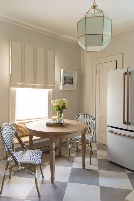 Kitchen breakfast nook renovation with white and gold refrigerator, lantern pendant, French cafe chairs, dining bench, and striped Roman shade #LTKMostLoved 

#LTKstyletip #LTKhome