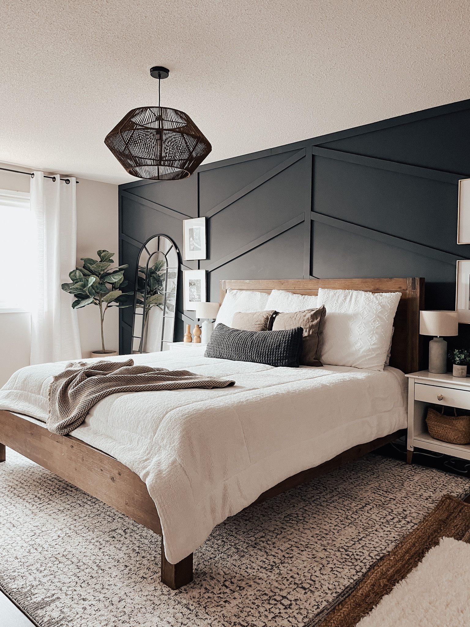 Primary Bedroom design-layered area rugs with white comforter. A rattan pendant light and an arched mirror in the corner. 

#primarybedroom #arearugs #homestyle #archedmirror #woodenbedframe

#LTKsalealert #LTKhome #LTKstyletip