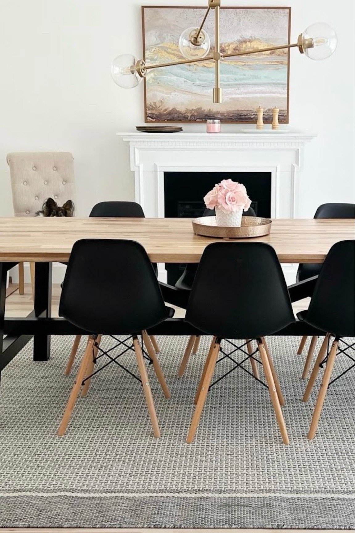 🖤Our dining room from our previous old house flip 🤍✨ This was my favorite room 🥰 We transformed it from an old, dark, smoky office (it had brown walls and old filthy carpets) to this bright & airy, minimalistic decor dining room. 
Table is the Skogsta (acacia wood) from IKEA. It’s huge and comfortably seats 8. We replaced it with the same version but in solid oak (the Mockelby) in our new home because we loved it so much. 
🖤 these chairs are a MUST with children. So easy to clean down and very durable! We had 6 white and 6 black. We also had the taller bar stools in white (linked) at our kitchen island. Sold the black with our old house and now use the white ones in rooms with desks. 

#LTKStyleTip #LTKFamily #LTKHome